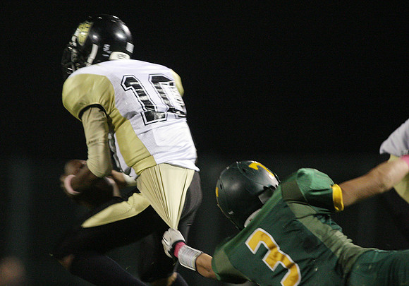 Tracy's Luke Hanna (3) and Chavez's quarterback,  Marcus Sanders (10)
