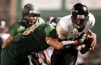 Chavez's quarterback,  Marcus Sanders (10) and Tracy's Bruce Russell (33)