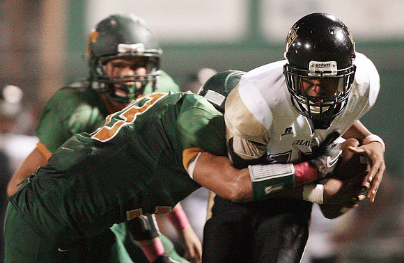 Chavez's quarterback,  Marcus Sanders (10) and Tracy's Bruce Russell (33)